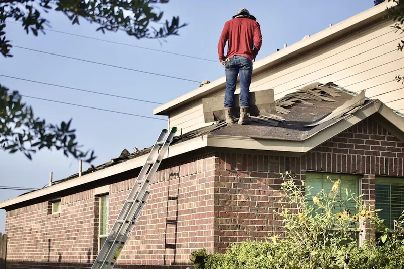 Professional roofer working on a residential roof in Niantic